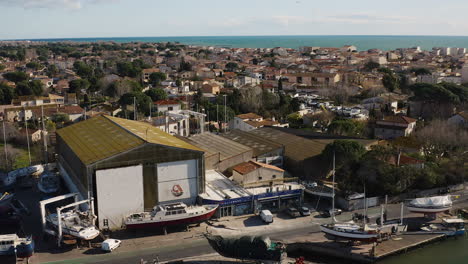Ship-repair-yard-aerial-drone-shot-sunny-day-discovering-Grau-d'Agde-city